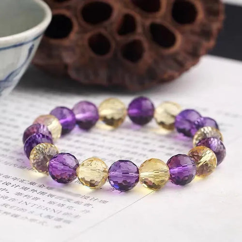 Handmade ametrine bracelet with 128-facet crystal beads in a choice of diameters and symbolic designs.