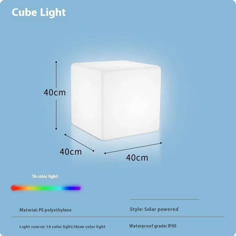 Modern white LED cube stool light outdoors, showing flat top and clean design.