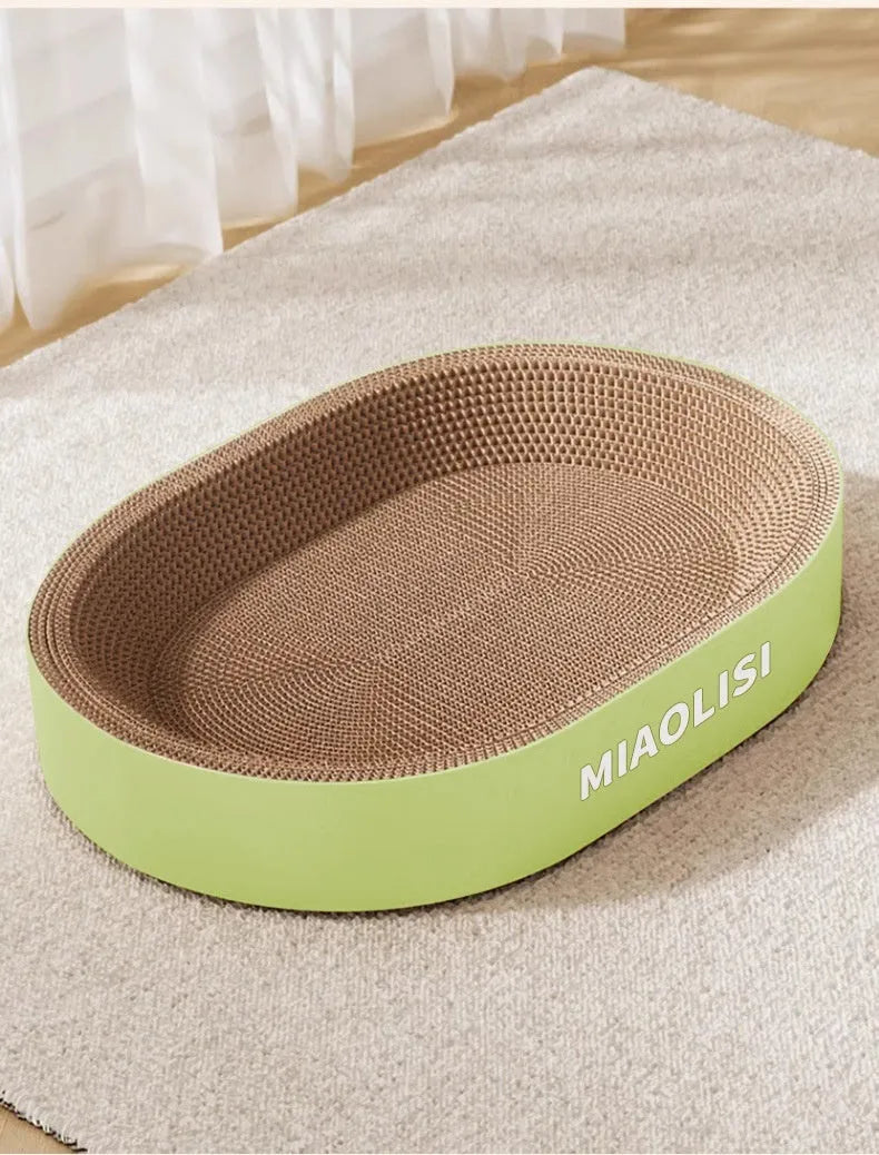 Green oval corrugated paper cat scratch board with a hollow centre forming a nest.