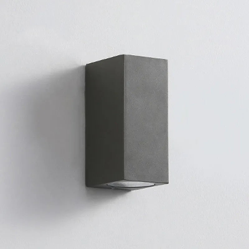 Modern black wall lamp with aluminium body, clear glass shade, and silicone rubber accents.