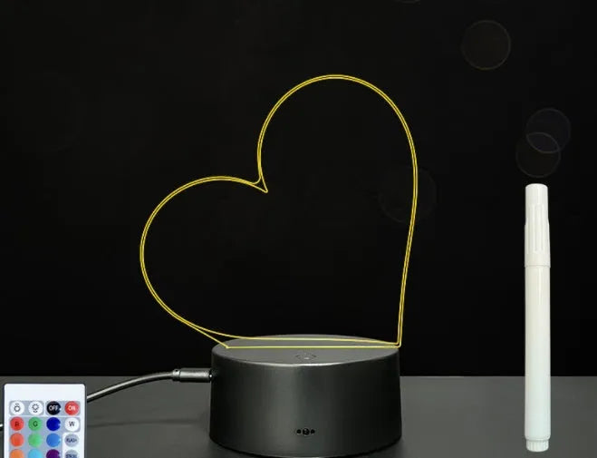 Black 3D acrylic LED message board night light with remote control and pen on desk