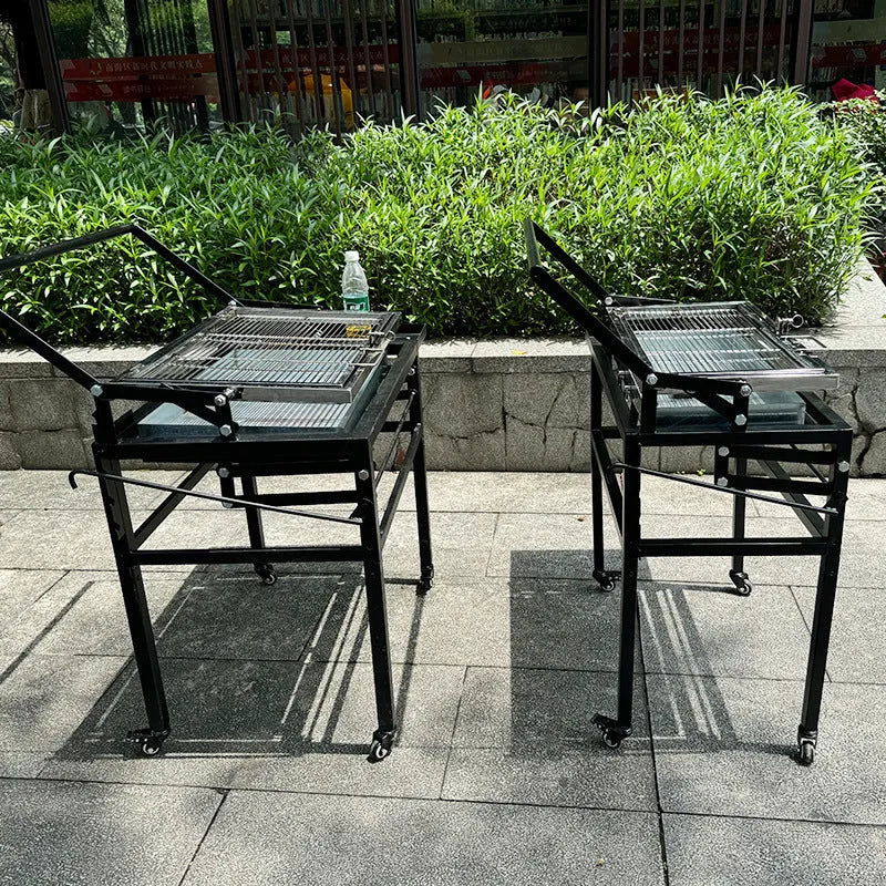 Large foldable portable charcoal BBQ grill and stove for courtyard use.