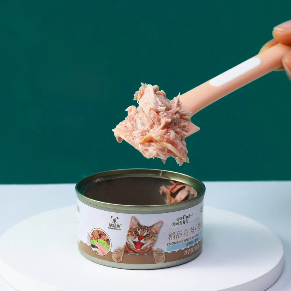 Green long-handled pet feeding spoon for scraping canned cat or dog food