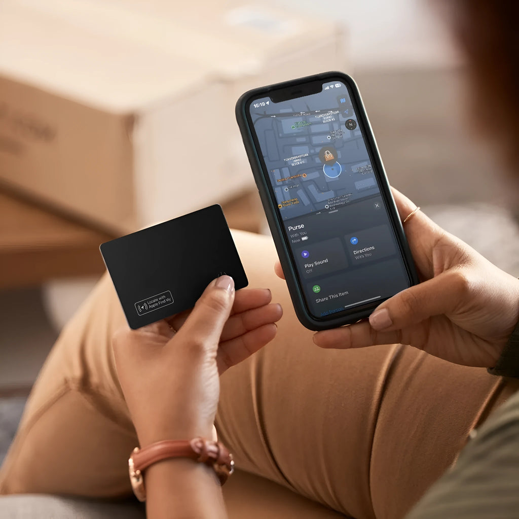 Black anti-lost alarm card for Apple devices shown next to a wallet.