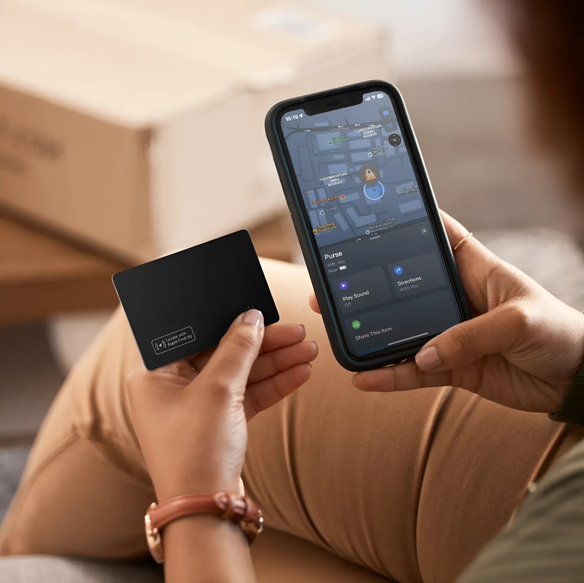 Black anti-lost alarm card for Apple devices shown next to a wallet.