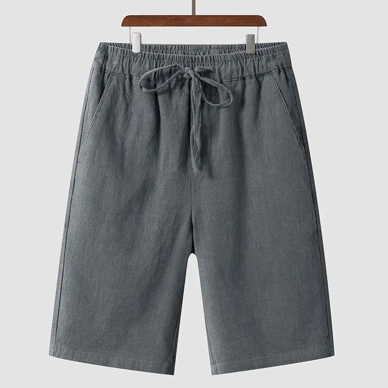 Men's loose-fit linen shorts in a cropped mid-length style with an elastic waistband.