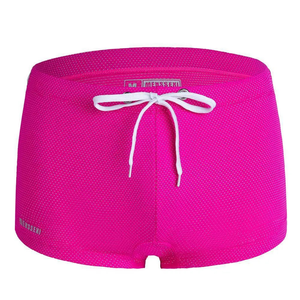 Men's low waist nylon swimming trunks in a solid colour on a white background.