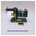 Steel alloy watch bracelet pin removal tool machine on a workshop bench.