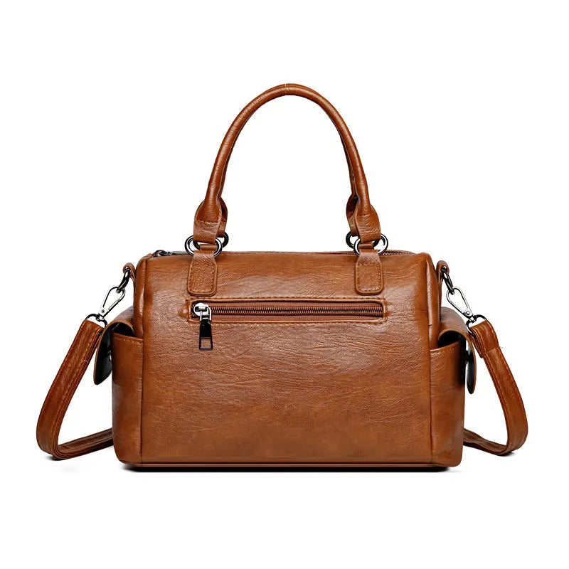 Vintage-style large square messenger bag in PU leather with contrast stitching.