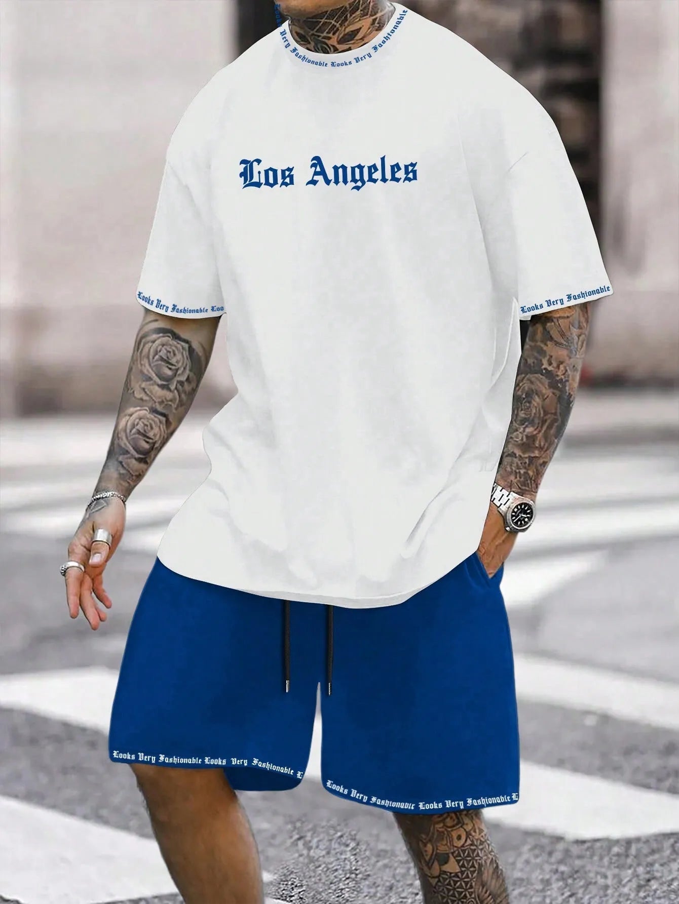 Men's grey sports short sleeve top and matching shorts set on hanger