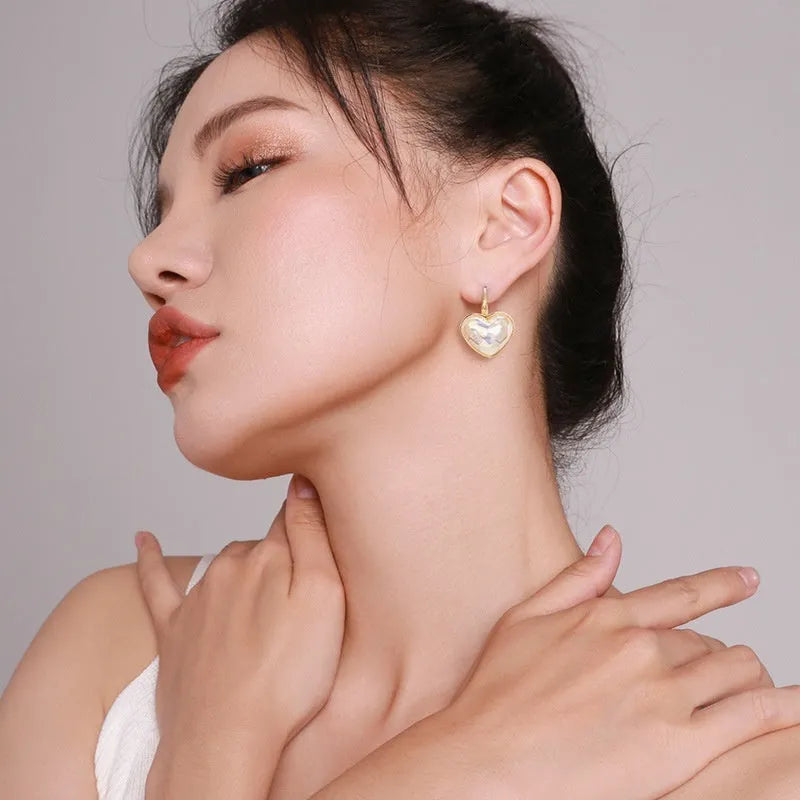 Gold women's ear clip with summer love design and clip-on fastening
