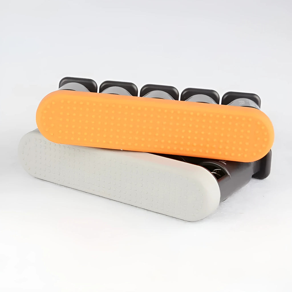 Grey and orange silicone finger trainer for hand muscle development.