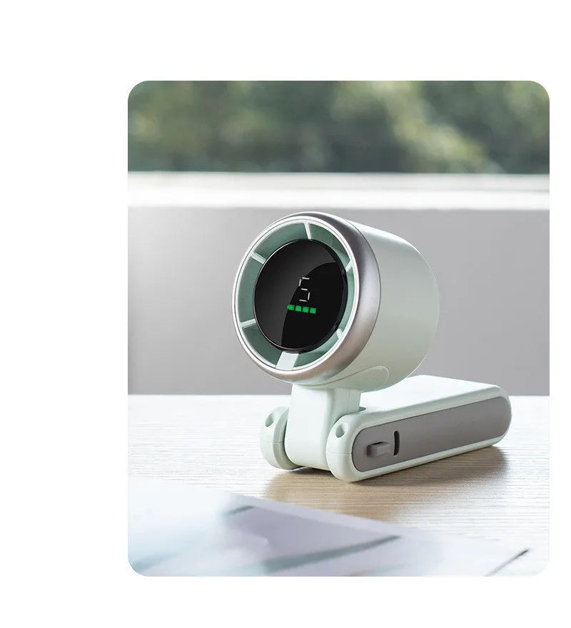 Mini hand-held folding fan in black and gray, rotated 180 degrees, showing plastic body and compact size