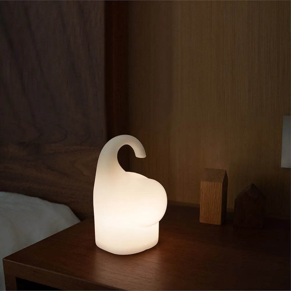 DOMI Elephant silicone night light with warm white glow on bedside table