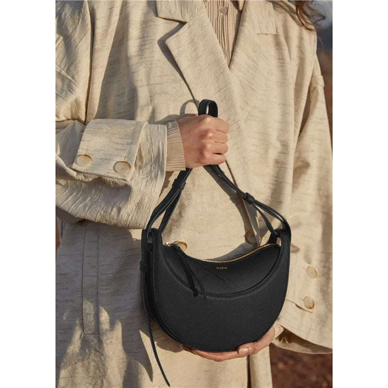 Women's crescent shoulder bag with litchi pattern texture, available in camel, black, chalk white, and elephant gray