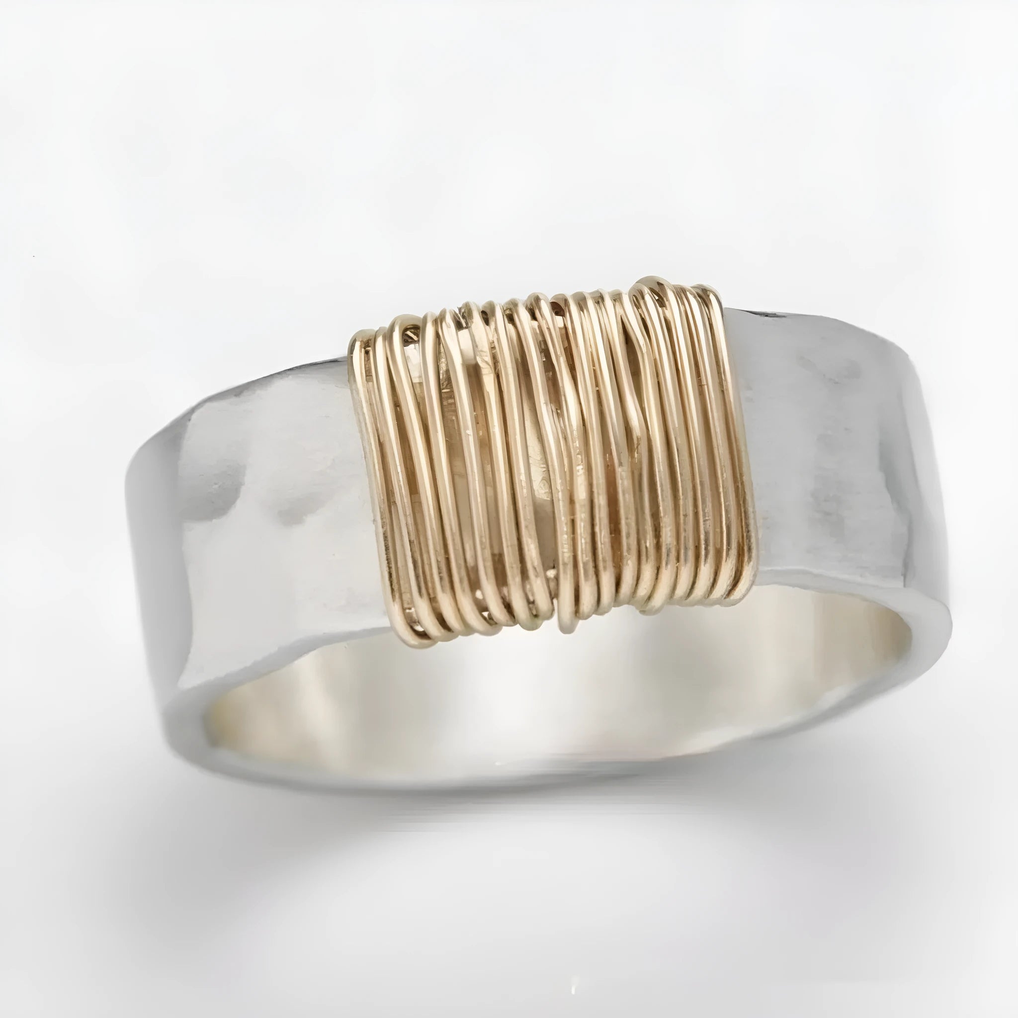 Silver golden geometric copper bracelet with an irregular coil and wide face ring design.