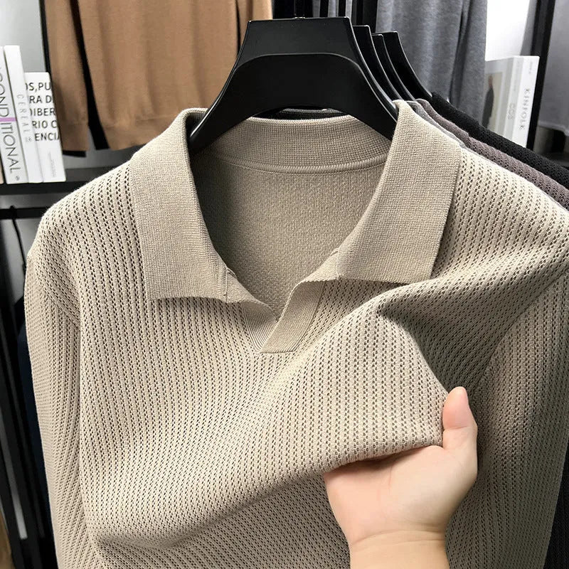 Men's loose green pullover sweater on a hanger, casual autumn wear