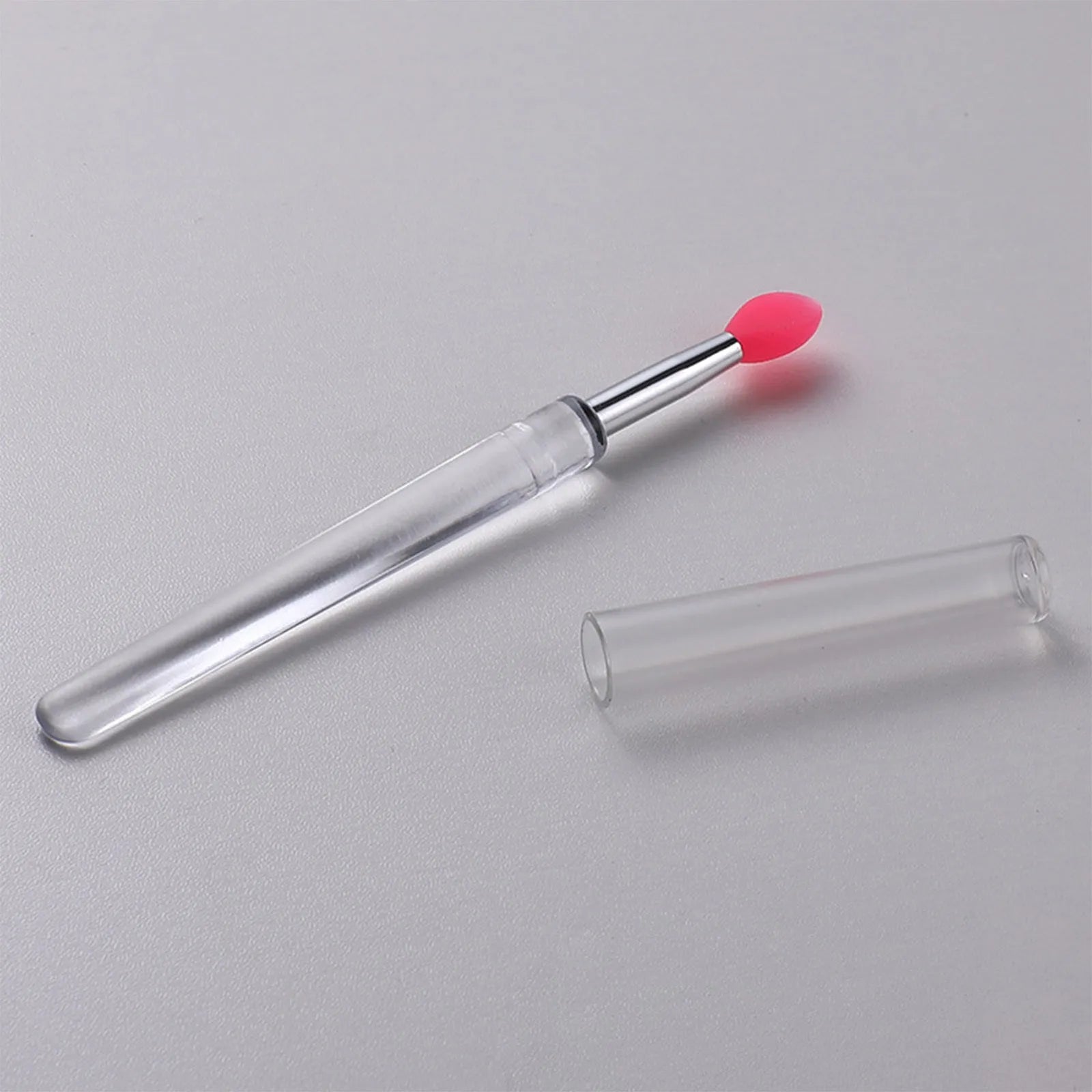 Set of reusable silicone lip brushes with caps in blue, pink, purple, red, rose red, skin colour, white, and yellow.