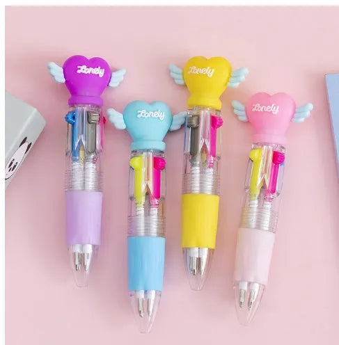 Cute cartoon four-colour press ballpoint pen with silicone grip and 0.7mm tip on a notepad.