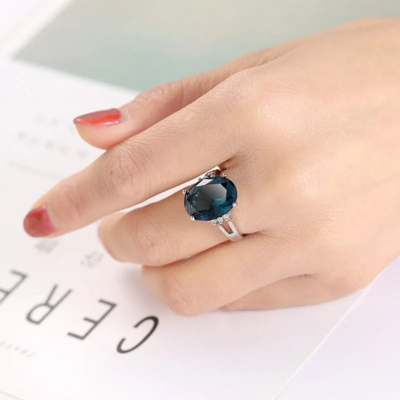A geometric blue black zircon ring made of copper on a size selection chart showing options 6, 7, 8, 9, and 10.