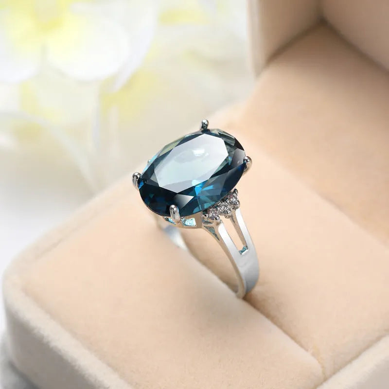 A geometric blue black zircon ring made of copper on a size selection chart showing options 6, 7, 8, 9, and 10.