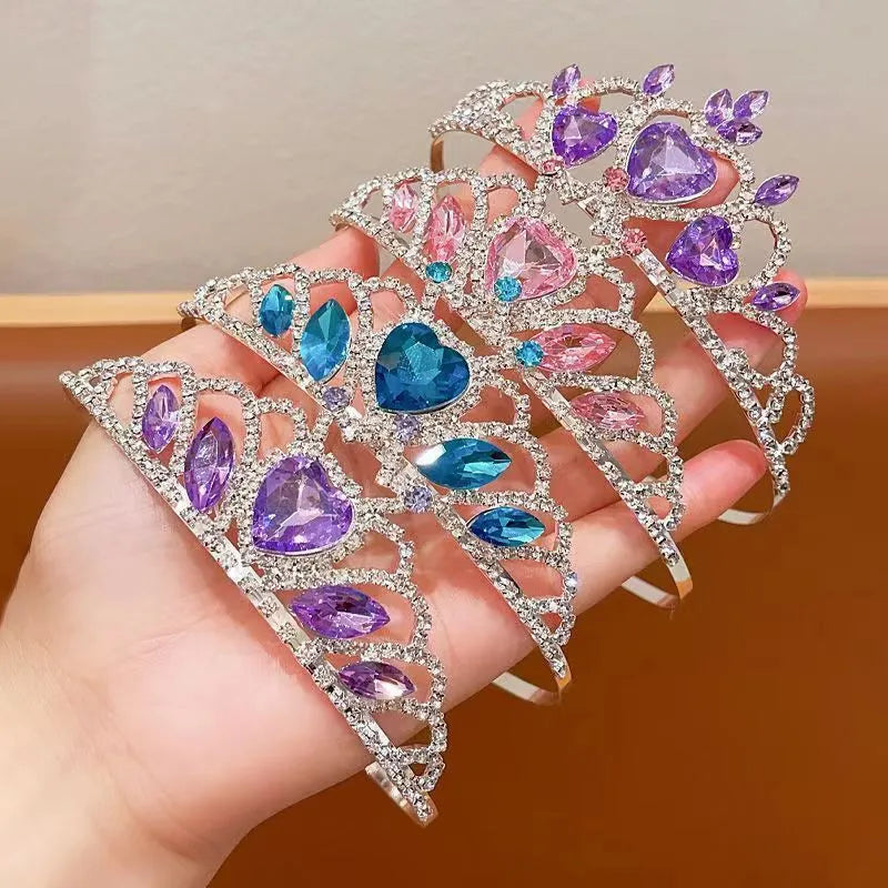 Children's electroplated alloy metal headband with crown shape and crystal decoration in pink, blue, or purple.