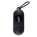 A compact black dog poop bag holder with a side hook and Velcro strap, shown next to a roll of waste bags.