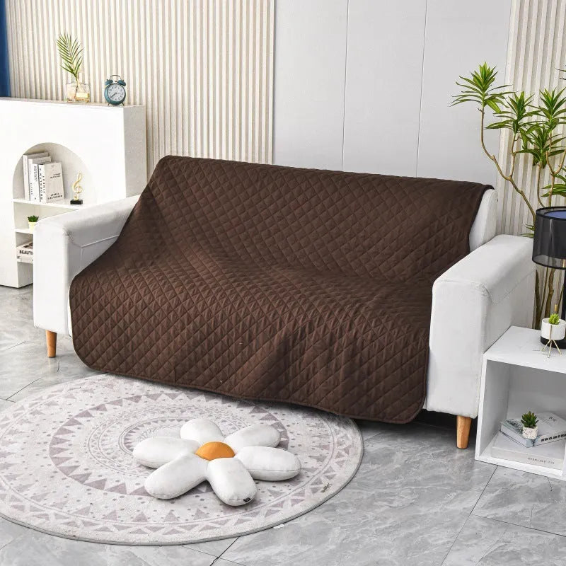 Reversible dog blanket sofa cover in grey and cream colours laid flat on a sofa