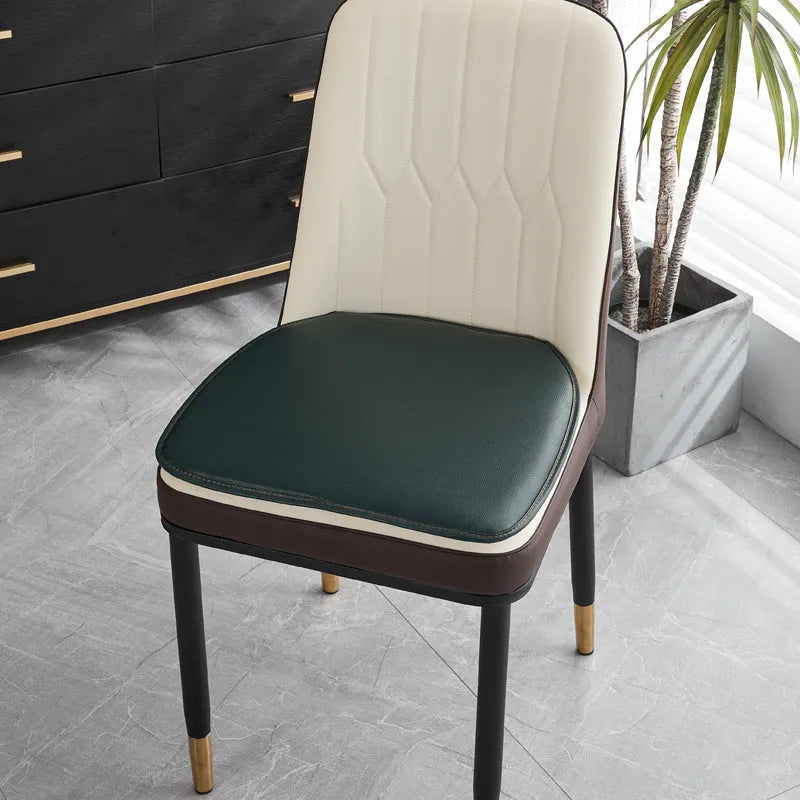 Leather horseshoe-shaped seat cushion in beige colour on a wooden chair, showing non-slip base.