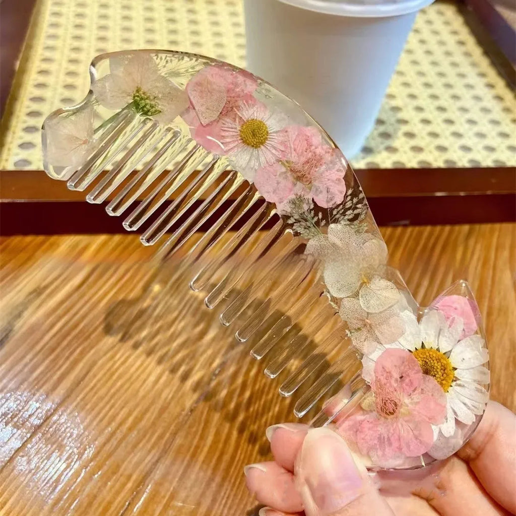 Small glossy resin hair comb with a reflective mirror finish, shown in one of three colour options.