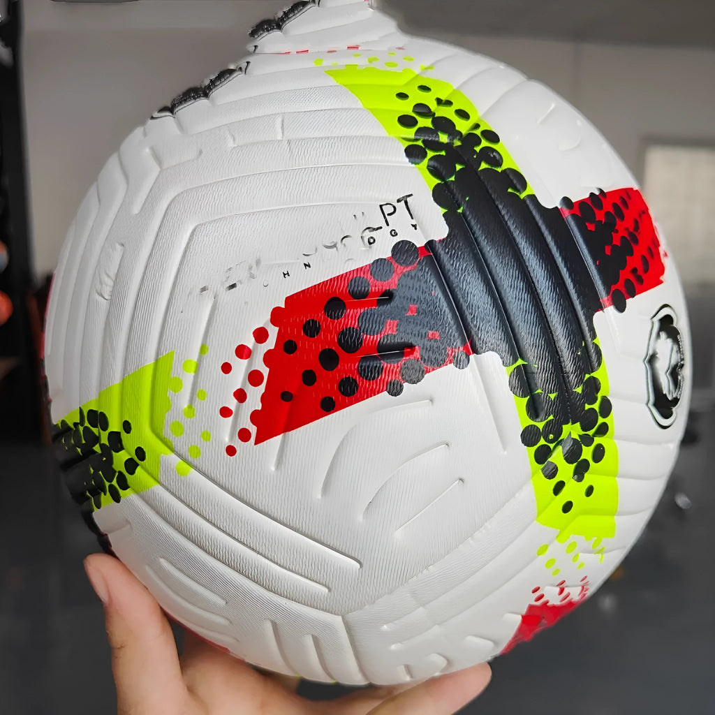 Fluorescent green Size 5 football with seamless thermal adhesive patches on a green pitch.
