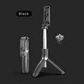 Extended black Bluetooth selfie stick with phone attached, showing remote control and folded tripod legs.
