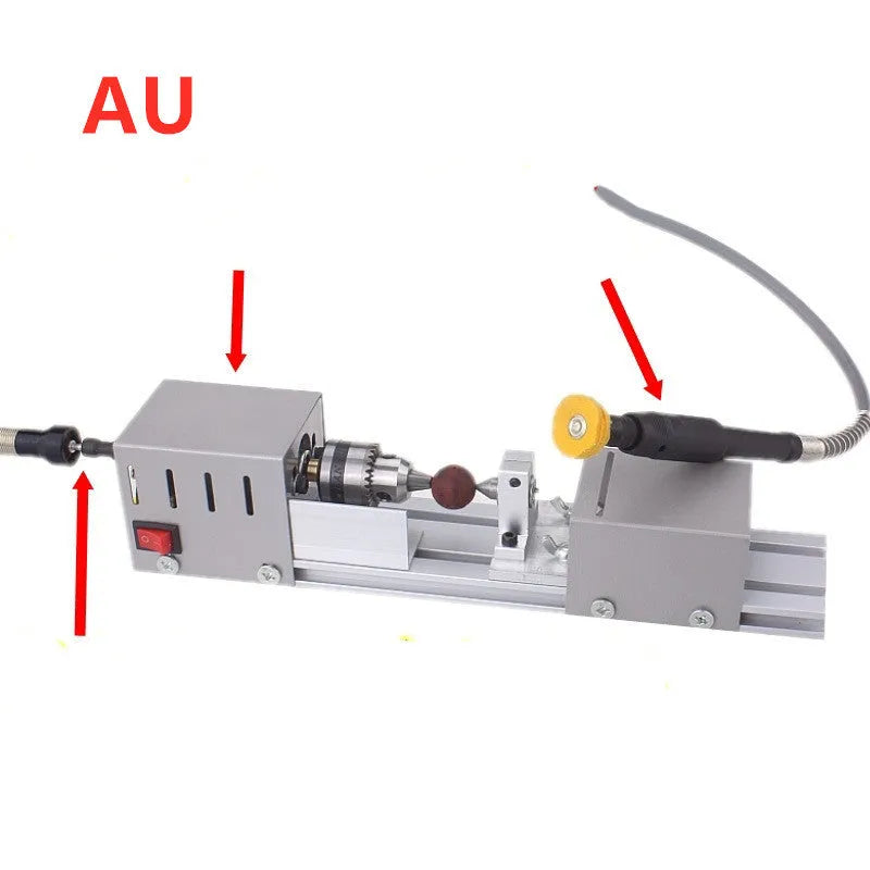 Mini metal woodworking lathe with silver finish and carving accessories on workbench
