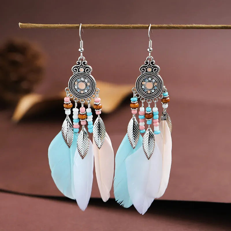 Round drop feather earrings with leaf patterning in alloy, available in multiple electroplated colours.