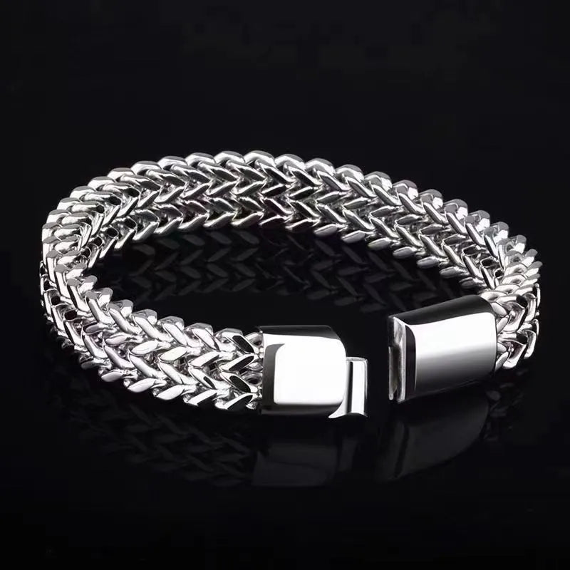 Men's geometric stainless steel bracelet showing front and back patterning with silver finish