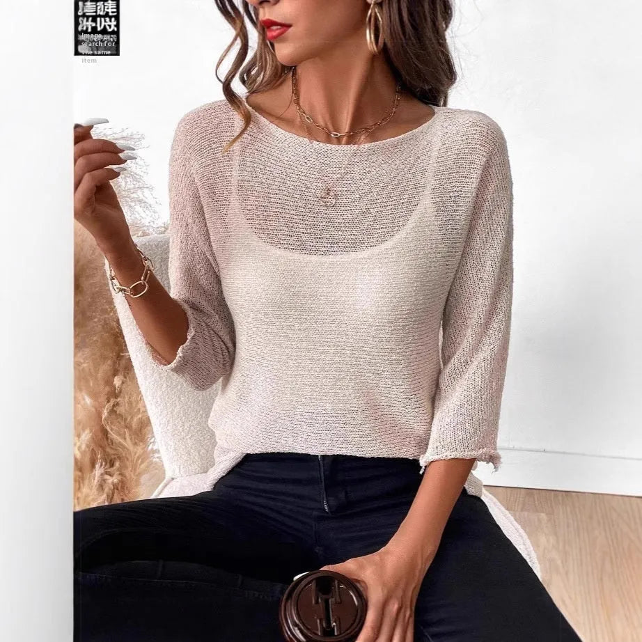 Women's light grey knitted off-shoulder top with a 3D textured pattern on a hanger.