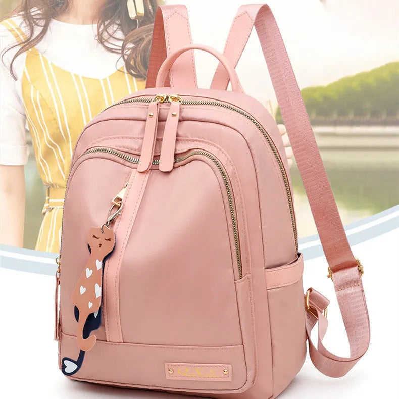 Women's black casual nylon backpack with shoulder straps showing external pockets and organised interior compartments