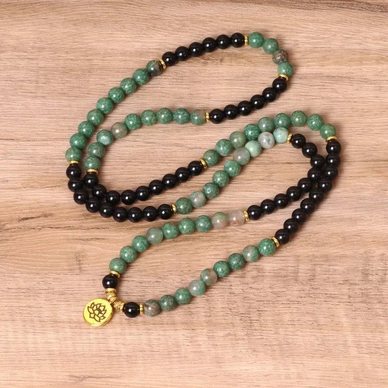 Green and black elastic beaded long bracelet made from alloy material.