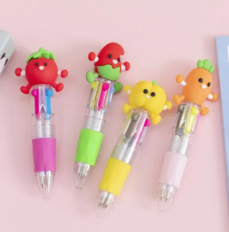 Cute cartoon four-colour press ballpoint pen with silicone grip and 0.7mm tip on a notepad.