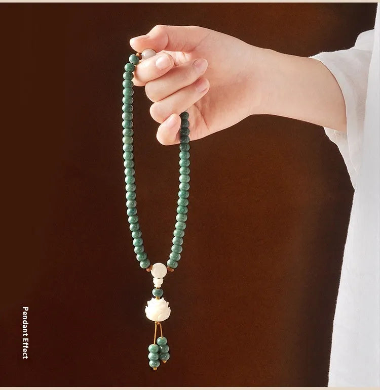 White jade and green sandalwood Bodhi seed bracelet showing either the safety buckle or lotus clasp fastening.
