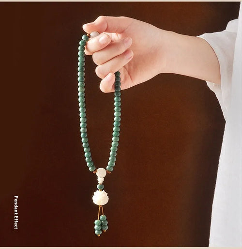 White jade and green sandalwood Bodhi seed bracelet showing either the safety buckle or lotus clasp fastening.
