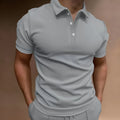 Men's grey cotton blend button t-shirt with short sleeves and a loose fit on a hanger.
