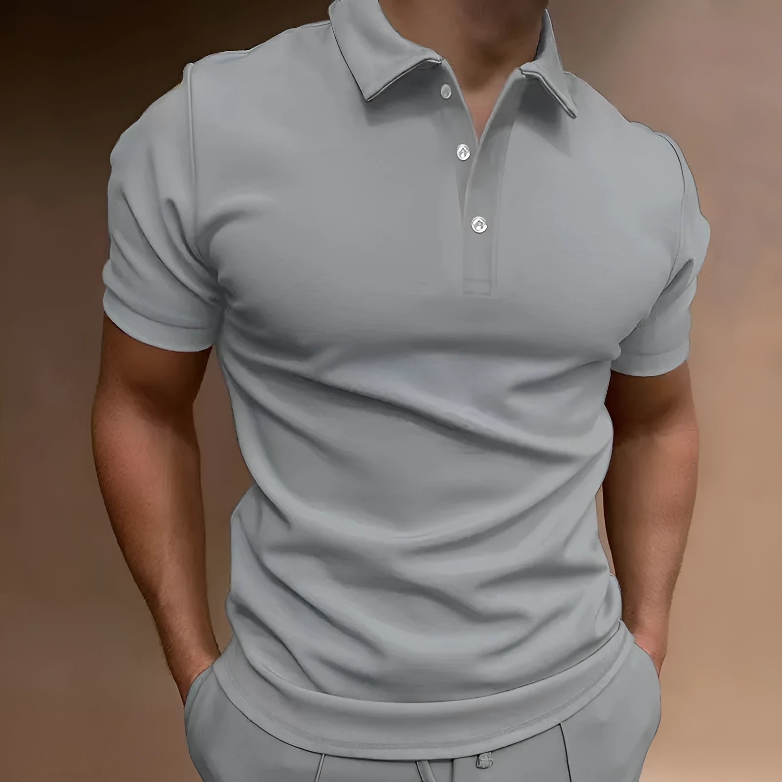 Men's grey cotton blend button t-shirt with short sleeves and a loose fit on a hanger.