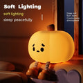 Pumpkin-shaped small night lamp in orange silicone with racket style design on table