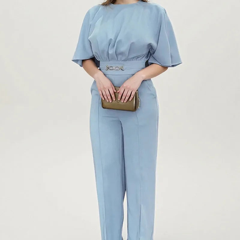 Blue two-piece polyester suit with long sleeves and trousers on a hanger