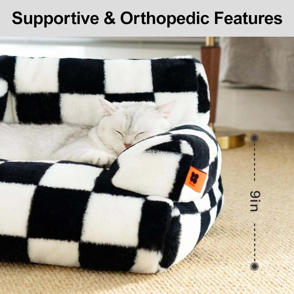 Fluffy cat couch bed in black and white with raised sides and non-slip base for cats and small dogs