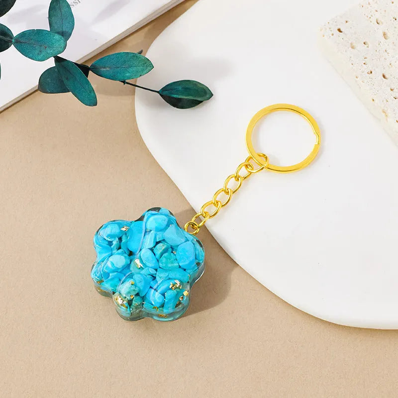 Small natural crystal cat's paw claw charm on a metal loop keychain