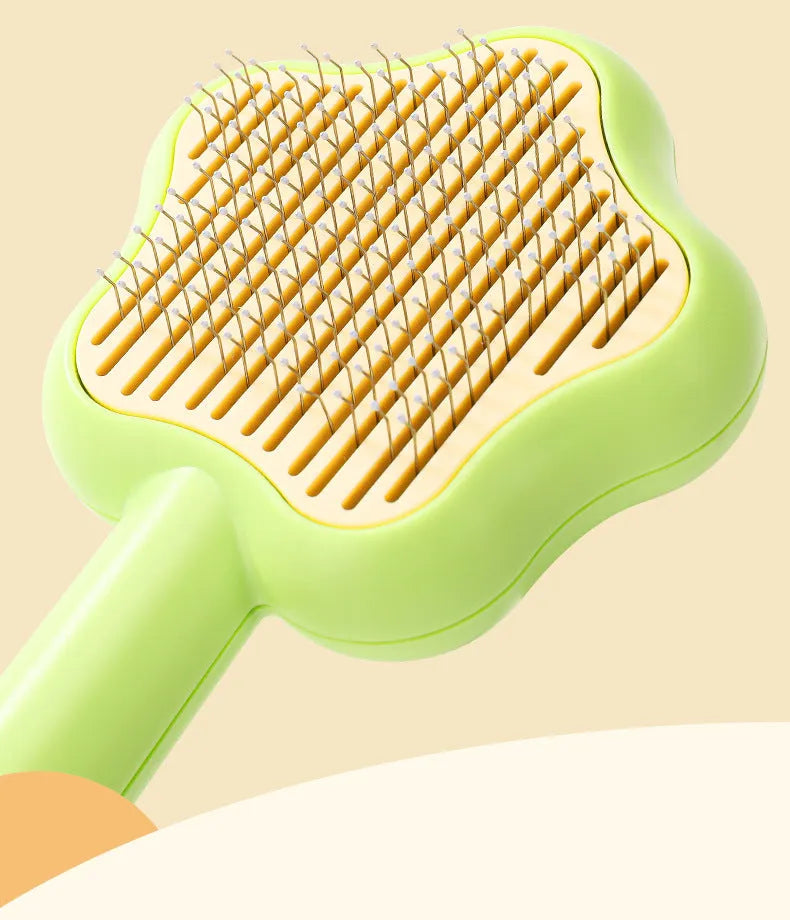 Green self-cleaning cat comb with stainless steel needles and retraction button