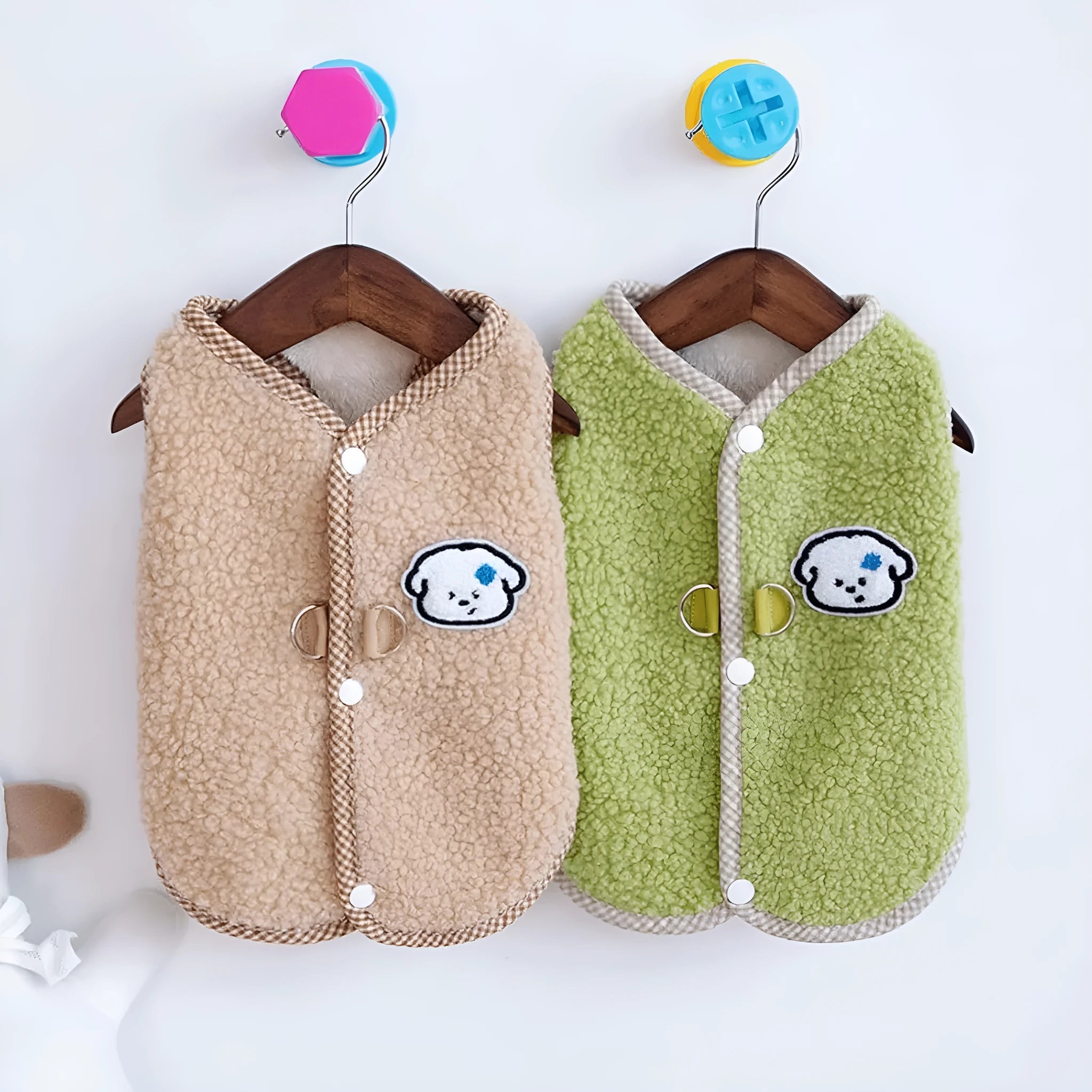 Green coral fleece dog vest with a metal leash ring on the back, shown on a small dog.