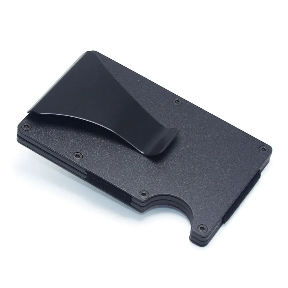 Slim black carbon fibre card holder wallet with geometric design on a table.
